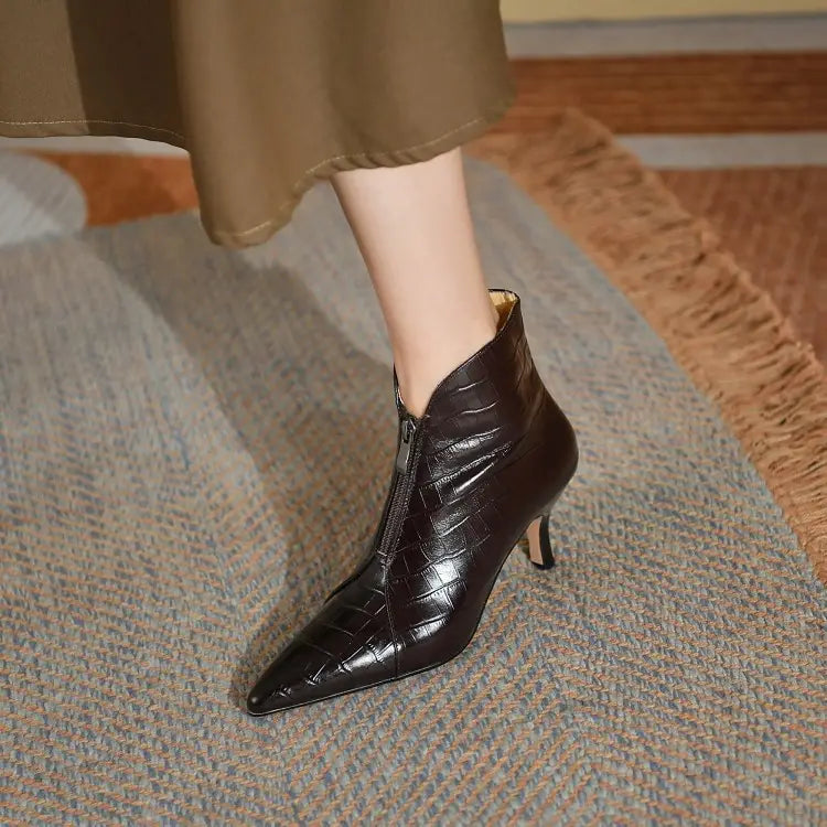 Black croc embossed leather stiletto ankle boot with pointed toe and slender heel shown from the back side.