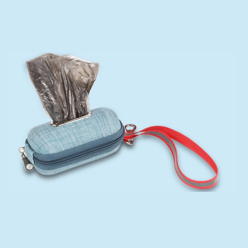 light blue textured fabric dog poop bag dispenser with a reflective red wrist strap and metallic silver zipper for convenient pet waste disposal.