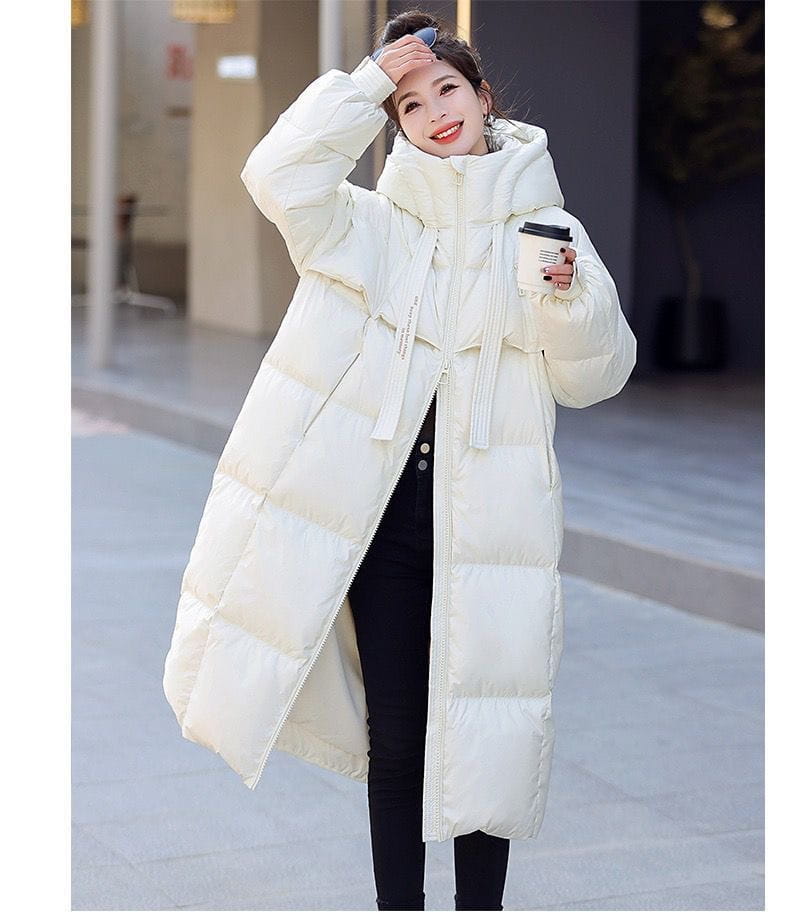 cream-colored long hooded puffer coat featuring a quilted down material with a front zipper for women