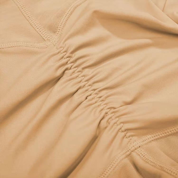 Beige high waist shapewear shorts with lace butt enhancer featuring stretch fabric with gathered seams and mesh paneling.