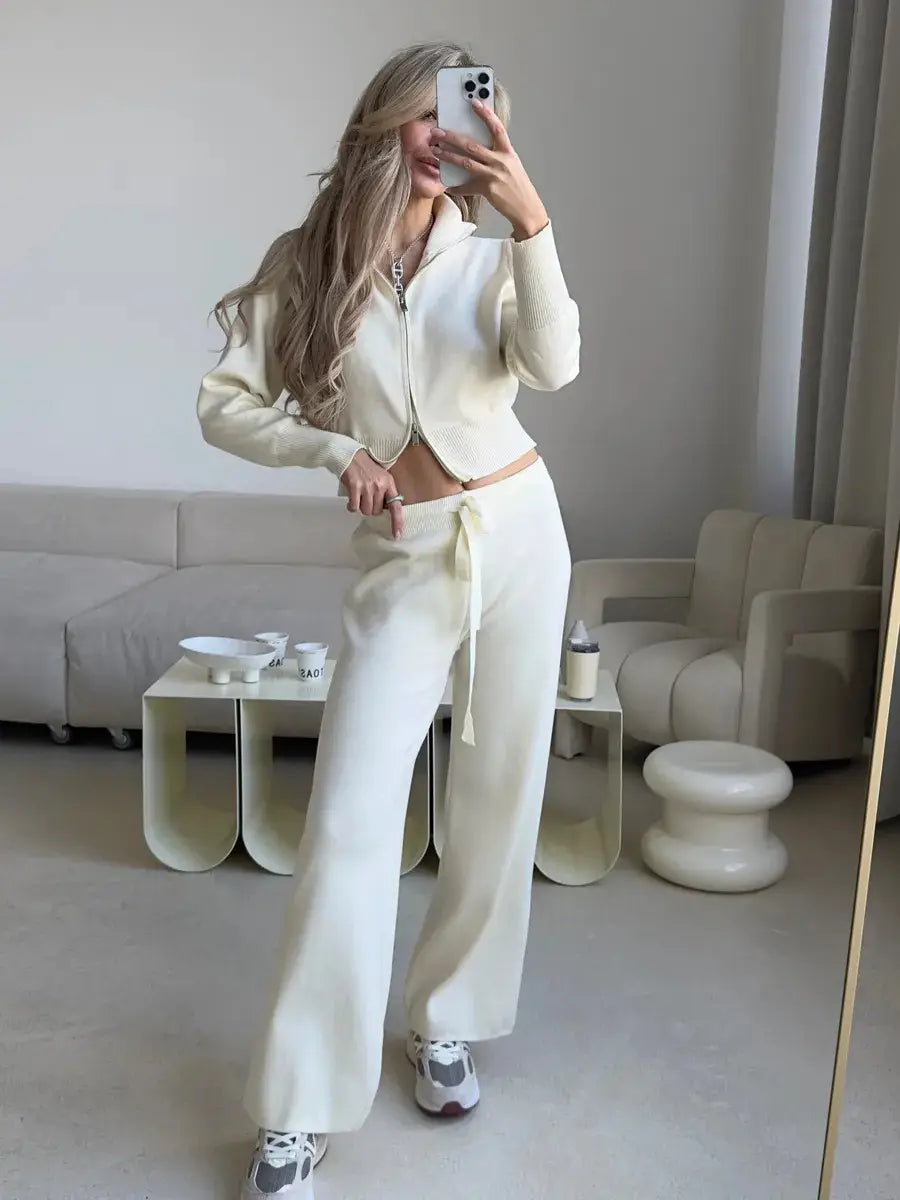Cream-colored women’s knit zip up cardigan and wide leg pant set featuring a cropped zip-up top and wide-leg pants with an adjustable drawstring waist.