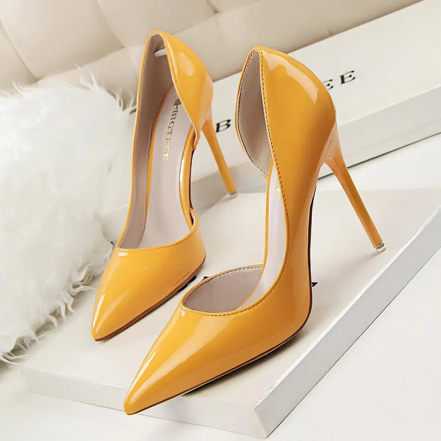 Vibrant yellow pointed toe patent leather stiletto high heels with a sleek silhouette and thin stiletto heel.