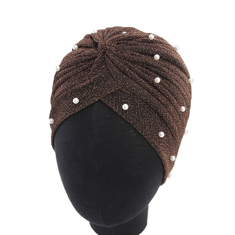 A shimmering brown pearl turban headscarf cap for women made of jacquard fabric and adorned with evenly spaced white pearls along its twisted textured surface.