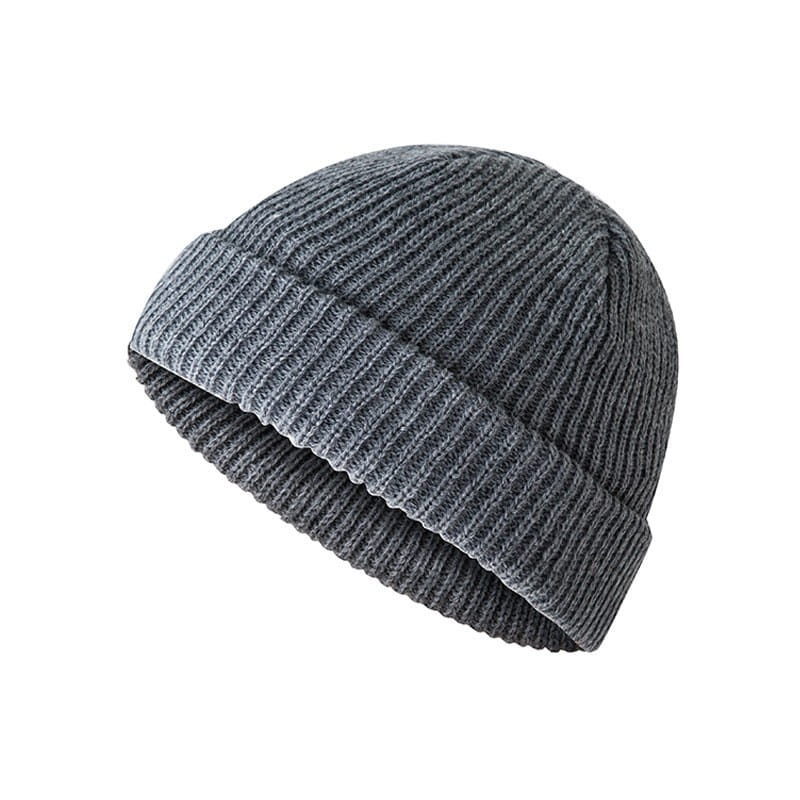 A dark gray ribbed wool beanie hat with a folded cuff made of knit fabric.