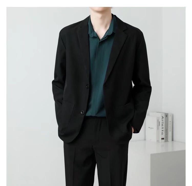 Men slim fit two button blazer in black with a sleek minimalist design and subtle textured fabric.