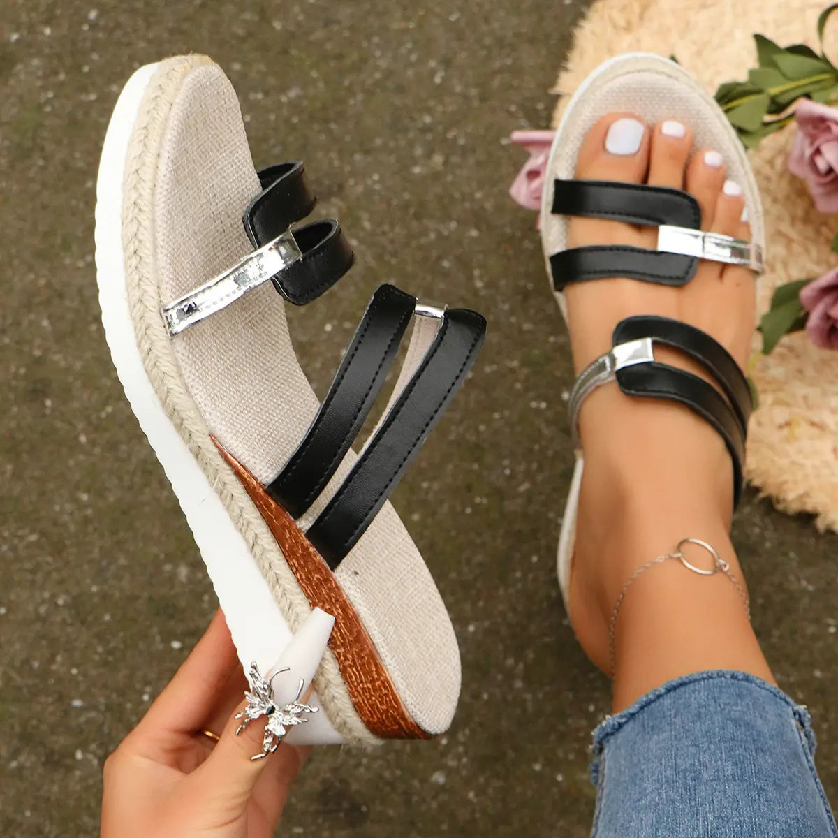 black and silver wedge sandals with woven espadrille heel and metal accents shown from the back side