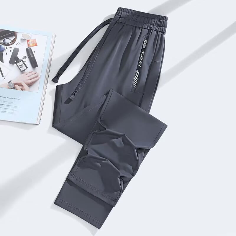 Dark gray anti-mosquito casual athletic trousers with a drawstring waistband and side zipper pockets featuring fashion branding.