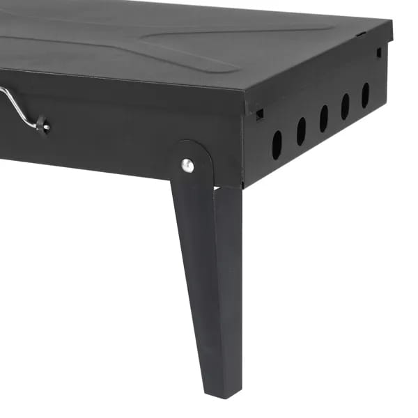 Black metal folding grill with a sturdy rectangular design and ventilation holes along the side for portable charcoal grilling.