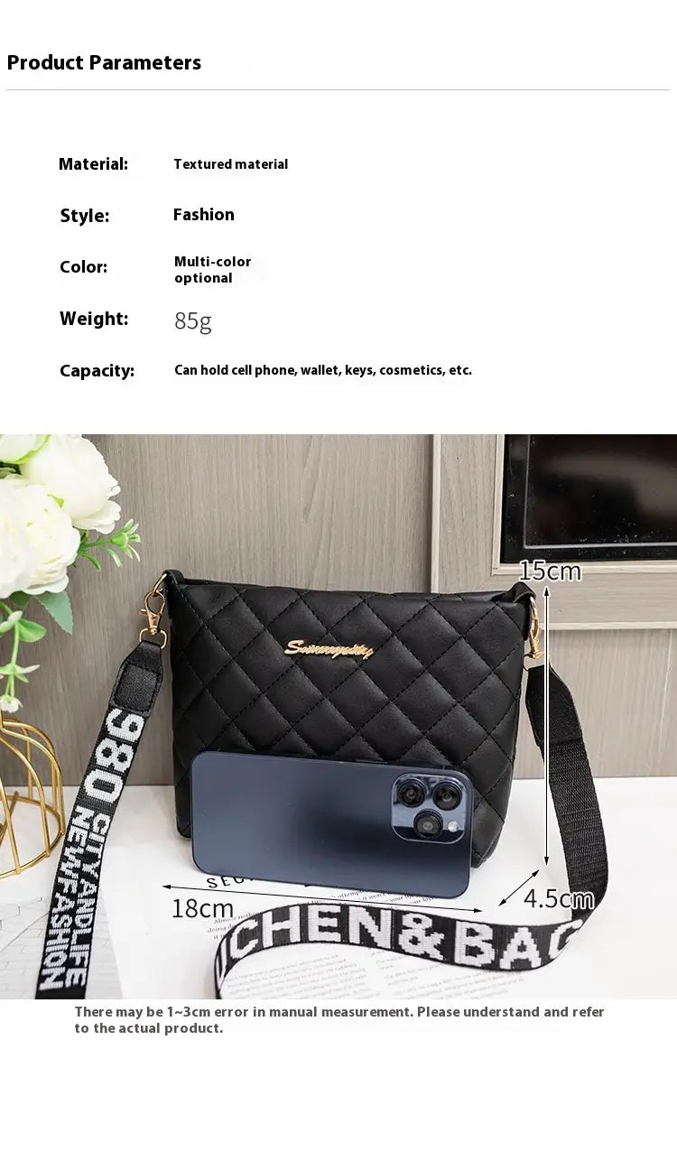 Black quilted chain messenger bag with gold-tone hardware and detachable striped crossbody strap featuring bold white lettering.