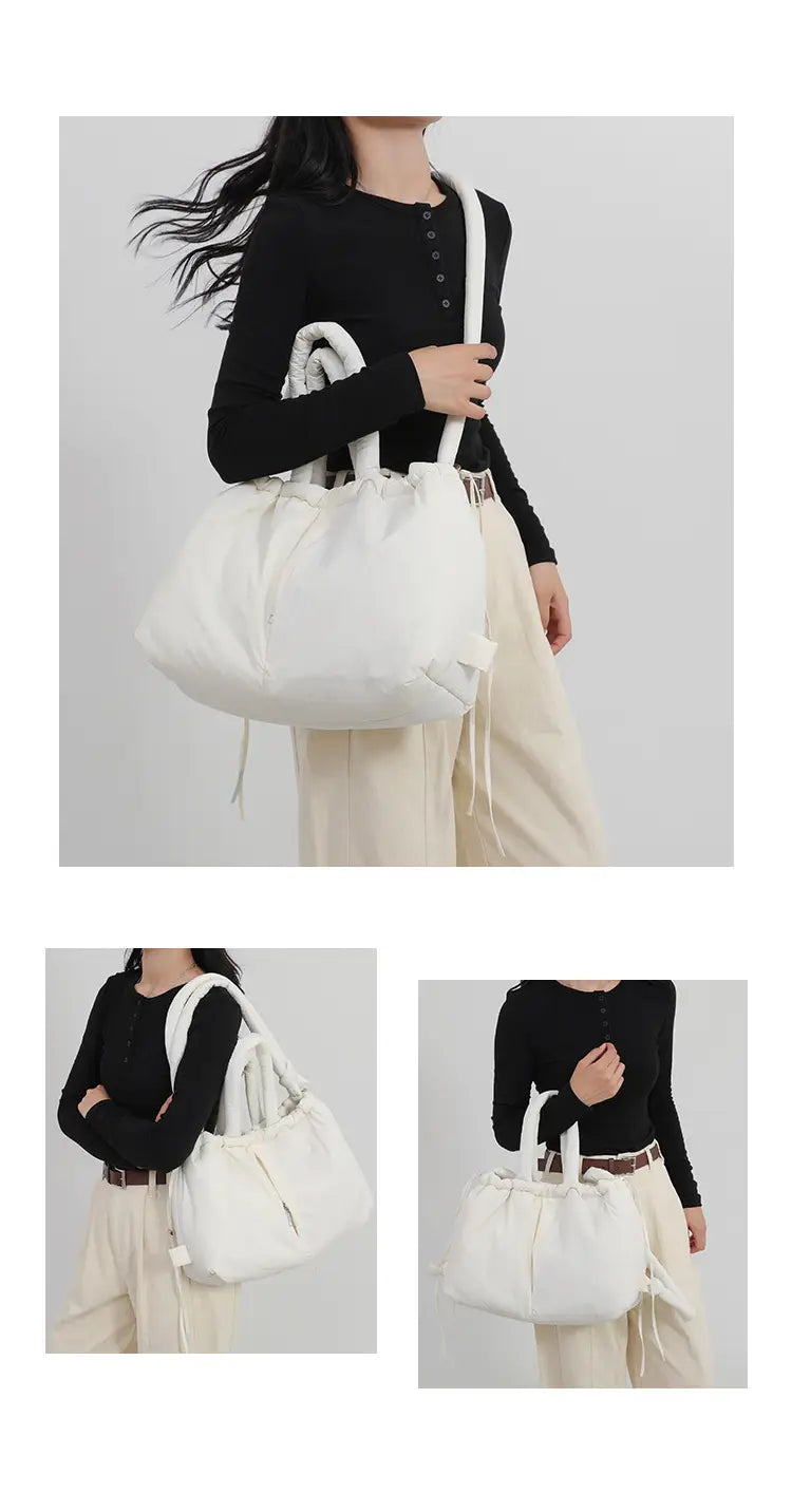 white drawstring quilted puffer tote bag with soft nylon fabric and structured handles designed as a lightweight shoulder bag