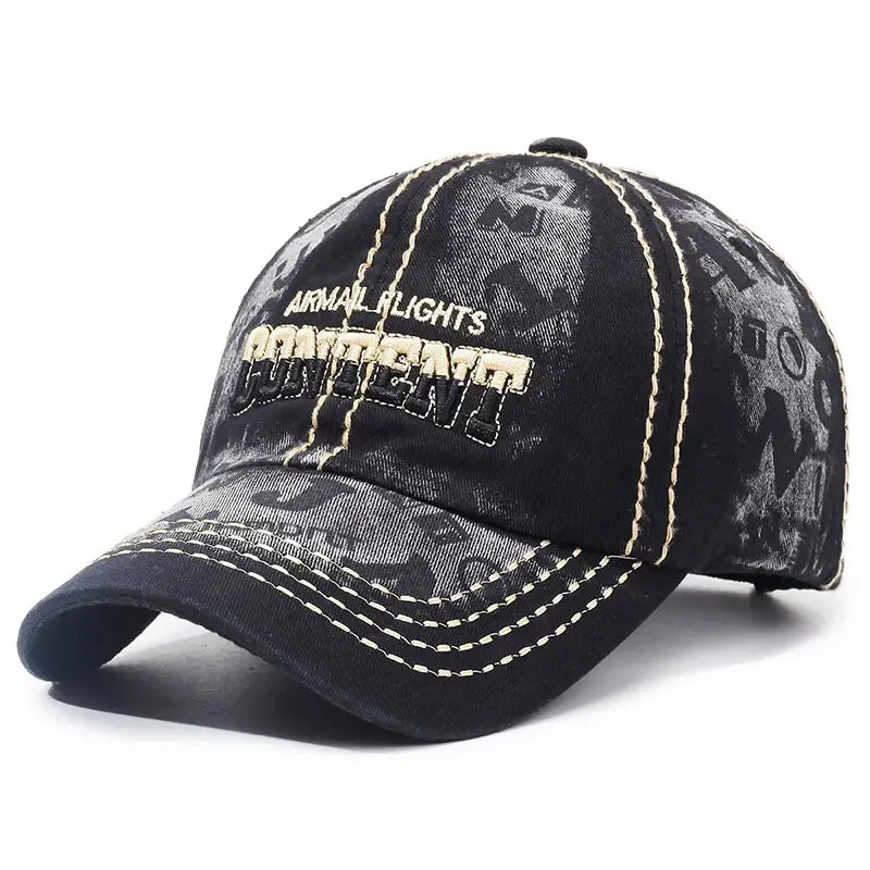 Black denim distressed washed cotton baseball cap with faded graphic print and contrasting cream stitching.