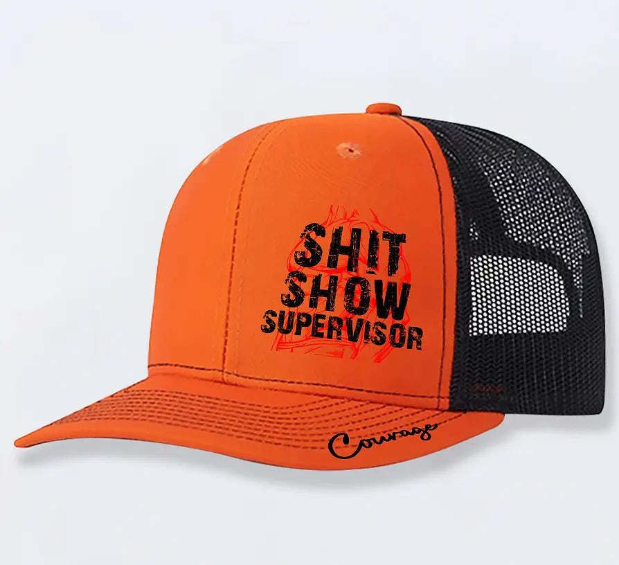 Bright orange novelty trucker hat for men with black mesh back and bold distressed black shit show supervisor graphic on the front.