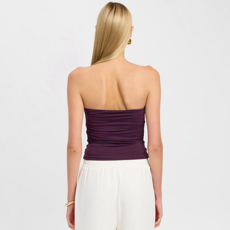 A strapless keyhole crop top in purple featuring a ruched design and fitted silhouette.