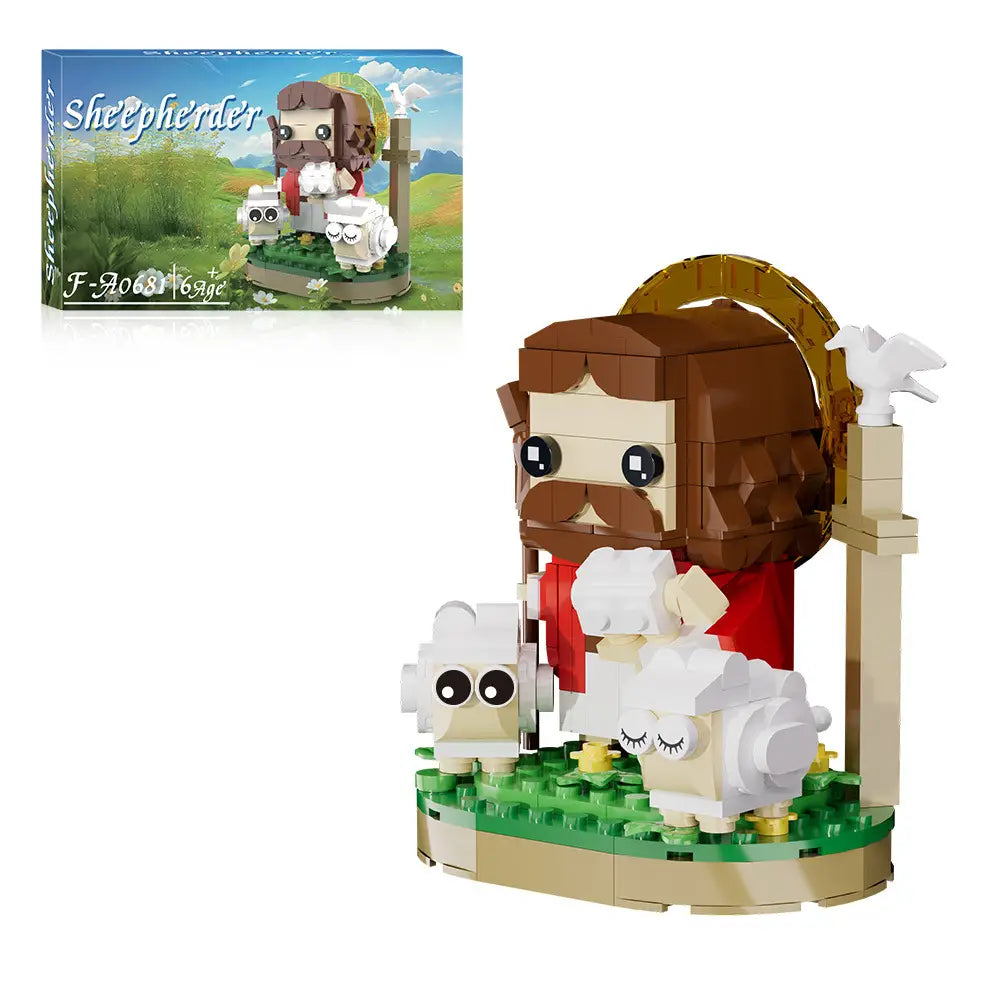 Le modèle de blocs de construction Jésus berger comprend une figure à la barbe et aux cheveux bruns, portant une robe rouge, avec deux moutons blancs et un halo doré sur une base verte.