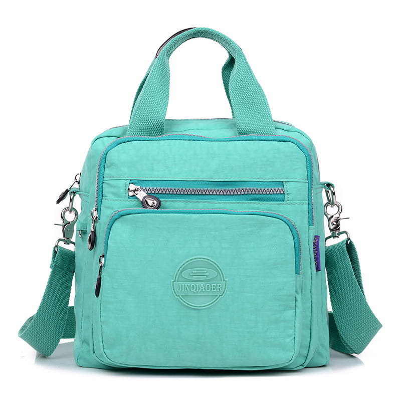 A teal nylon messenger bag made of lightweight canvas featuring a top handle and adjustable shoulder strap for versatile use.