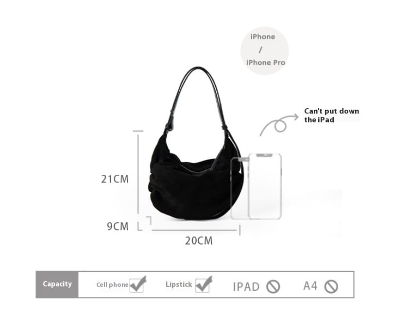 Black suede dumpling shoulder bag with a single shoulder strap designed as a slouchy crossbody hobo.
