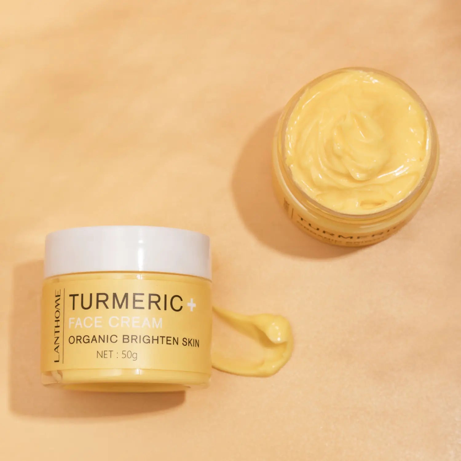 Pot de crème pour le visage au curcuma lanthomé jaune, contenant une crème pour le visage avec couvercle blanc et un poids net de 50 g, avec une formule biologique pour illuminer la peau, dans l’ensemble de soins au curcuma : huile éclaircissante et crème pour le visage.