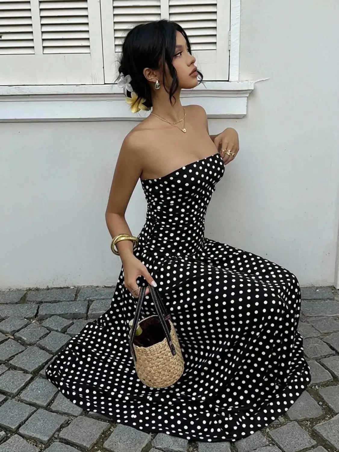 black and white polka dot off shoulder strapless maxi dress featuring a flowy fabric perfect for elegant summer occasions