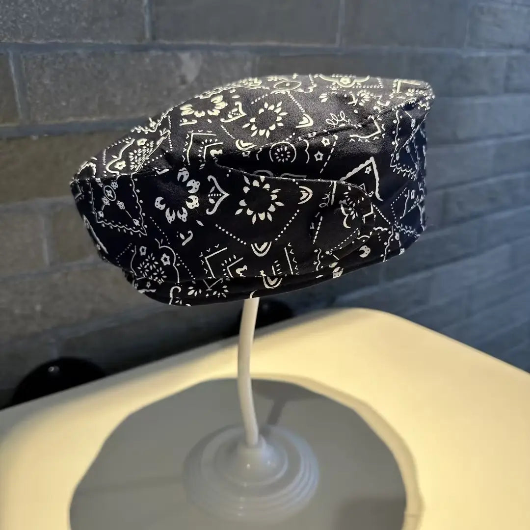 Printed Korean style fashion cap made of black bandana-patterned fabric with white floral and geometric designs.