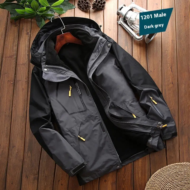 Men three-in-one waterproof winter sportswear jacket in dark grey with yellow zipper pulls and a fleece-lined hood.