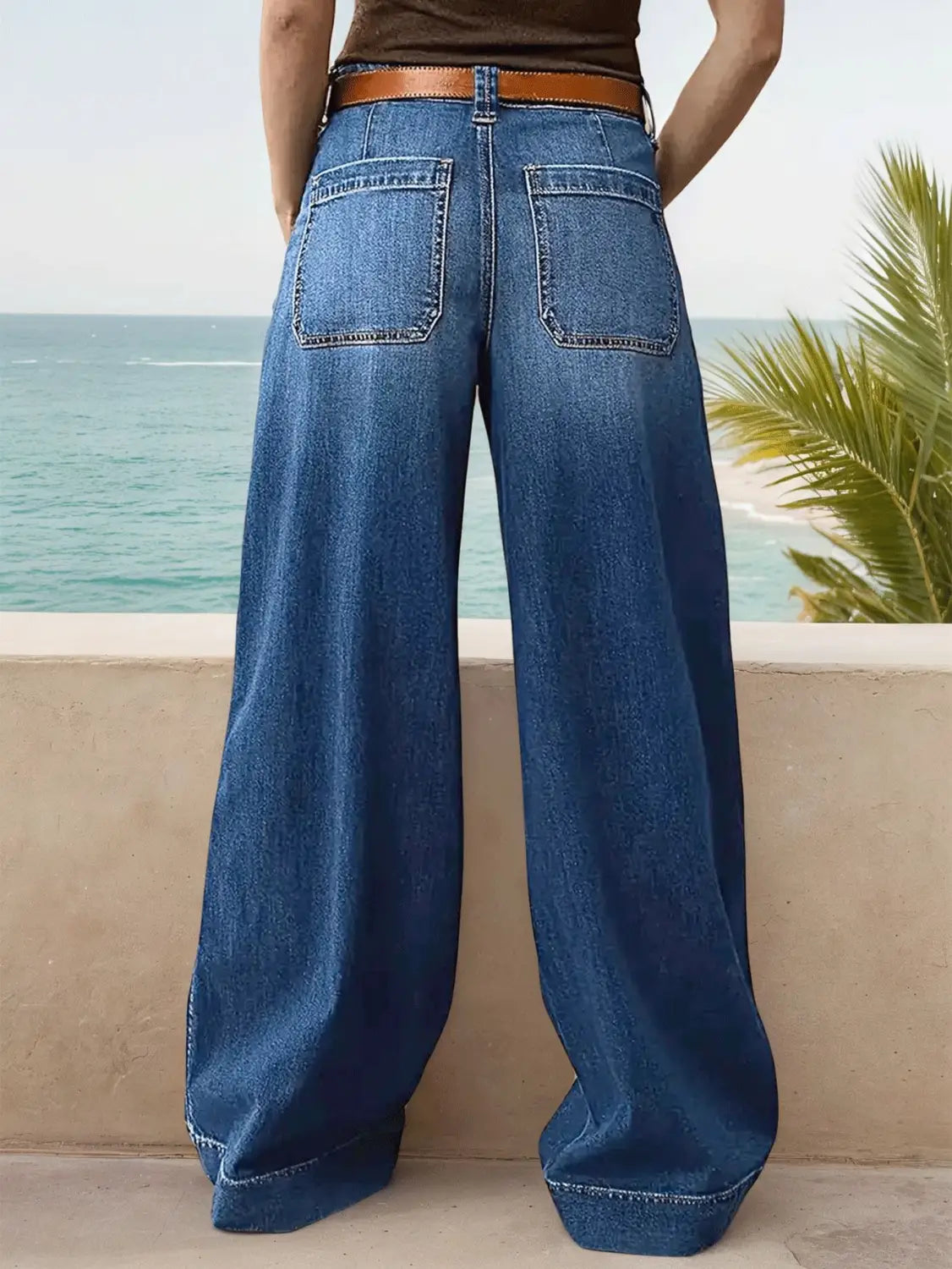 Blue denim wide leg pants with a brown leather belt designed for a stylish casual look.