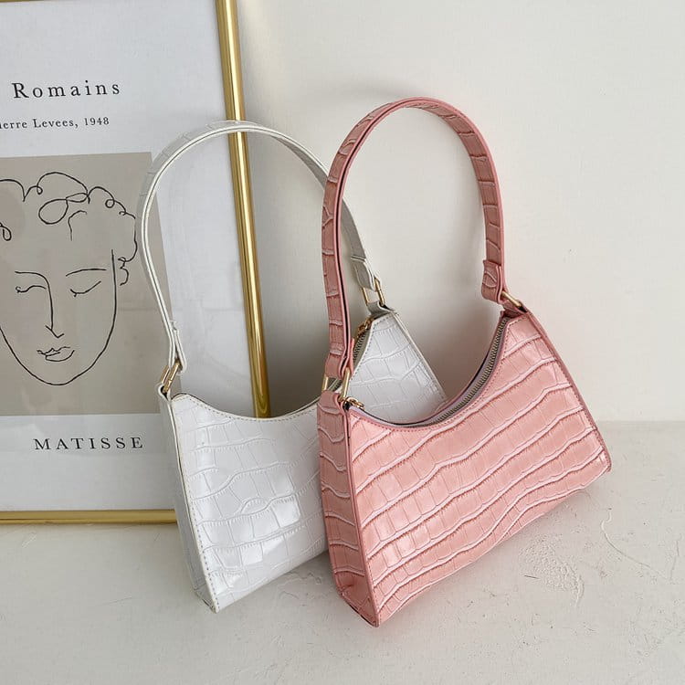 Pink crocodile embossed pu leather crescent messenger bag with structured curved silhouette and matching shoulder strap