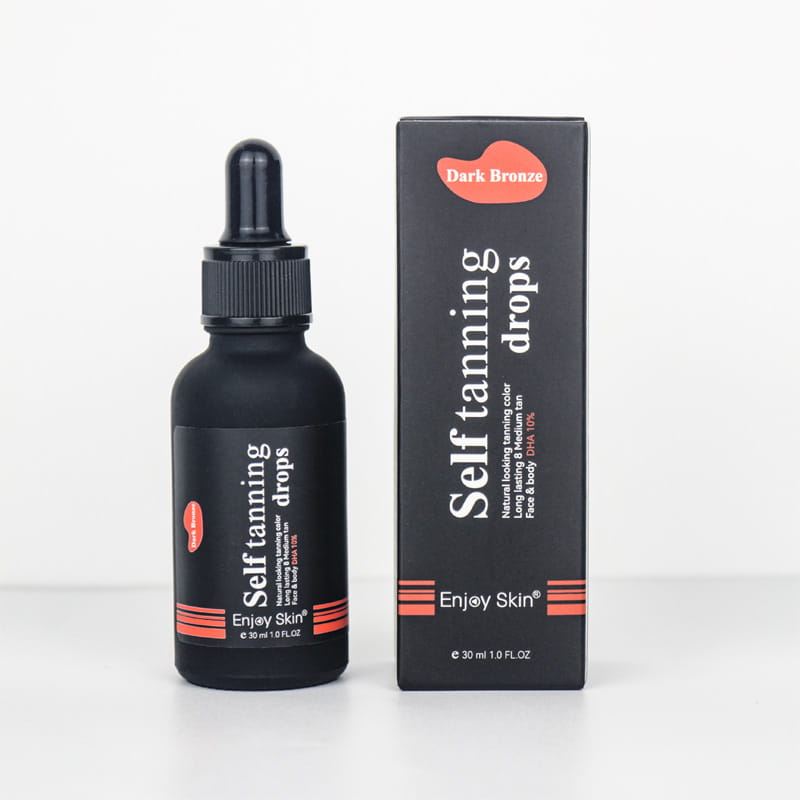Botella de vidrio negra de gotas autobronceadoras con ácido hialurónico 30 ml, con tapa del gotero negra y señalización naranja junto a su caja a juego.