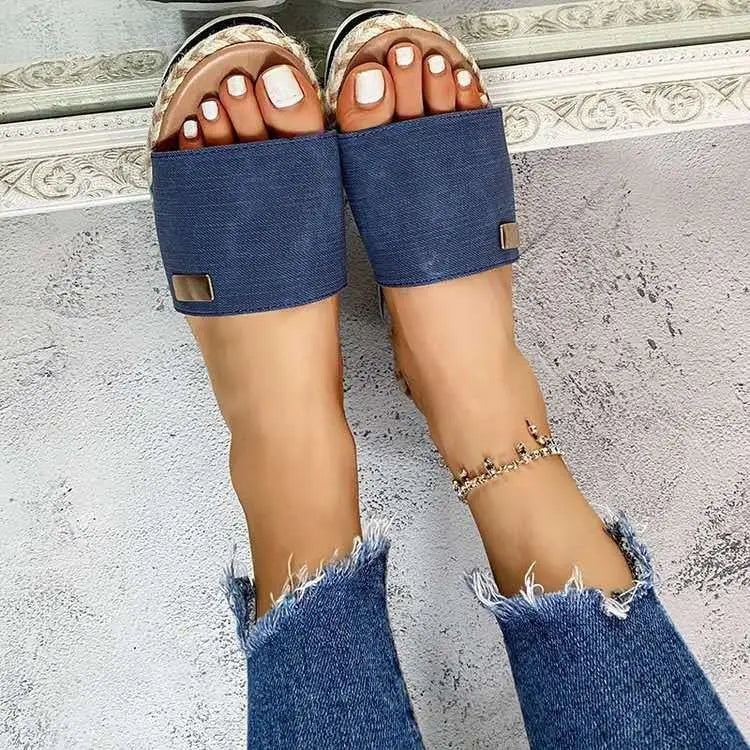 Platform wedge espadrille sandals in blue denim slide style with a woven straw footbed and metallic rectangular accents.