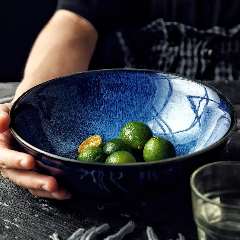Deep blue ceramic ramen bowl with a textured glazed surface and abstract white brushstroke patterns measuring 8.5 inches ideal for serving noodles.