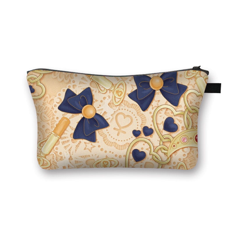 Beige cosmetic bag with navy blue bows and gold accents featuring a sailor moon-inspired design in a whimsical bow and lace travel clutch.