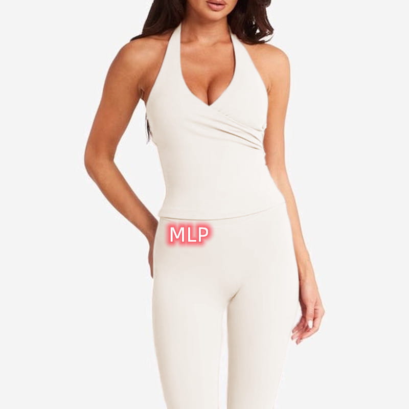 cream-colored halter-neck one-piece athletic bodysuit with draped front detail paired with pink high-waisted fitness leggings for workout and activewear use