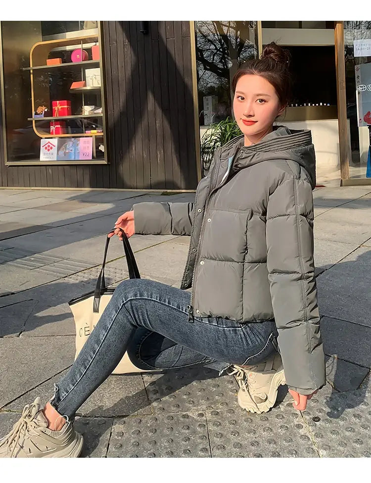 Gray quilted puffer women hooded short down jacket with front zipper closure and hood for cold weather.