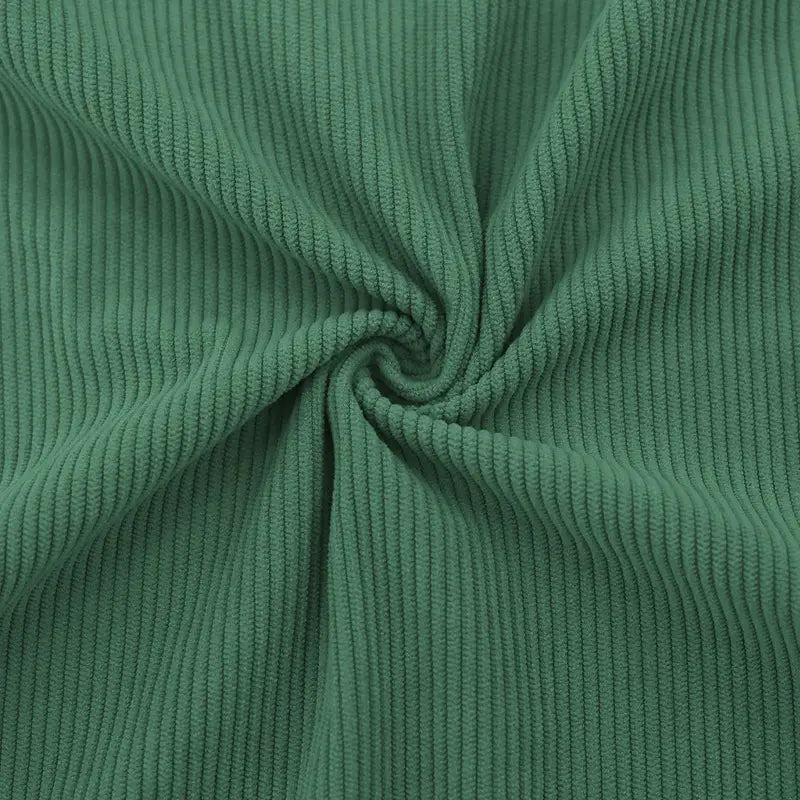 A slim fit corduroy patchwork pullover with contrast accents in soft forest green featuring classic ribbed texture.