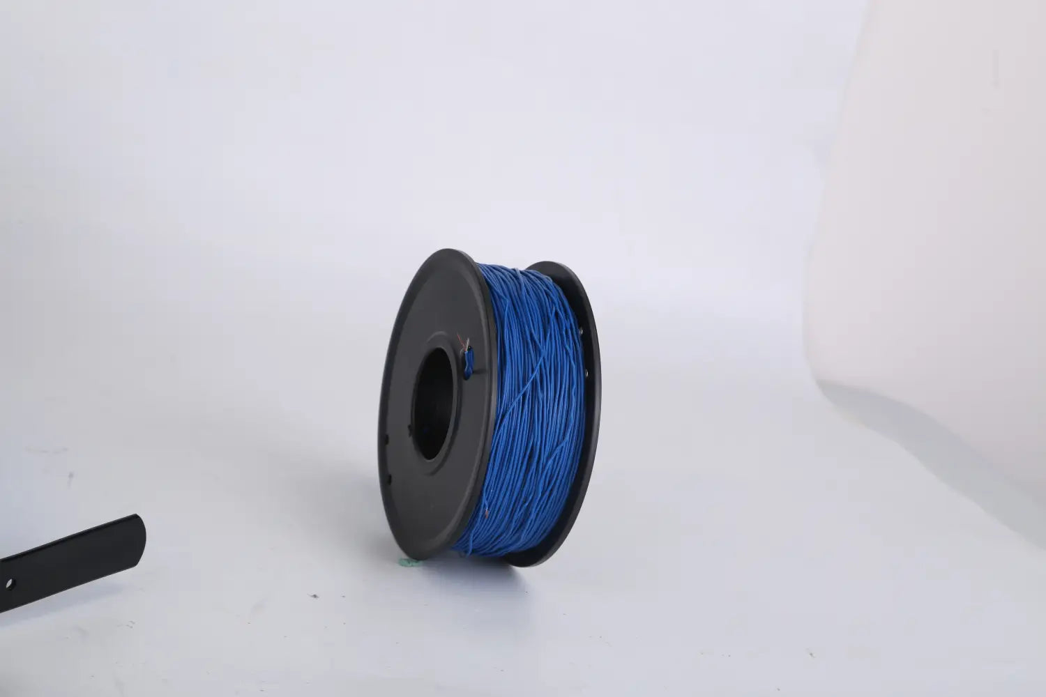 Eine Spule mit lebhaft blauem 3D-Druck-Filament, ordentlich um einen schwarzen Kunststoffkern für ein elektrisches Hundezauun-System gewickelt, wasserdicht nach IPX7 zur Tierkontainment.