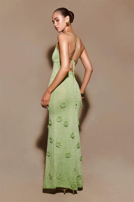 A long light green crochet floral lace mermaid maxi dress with delicate rose appliqués and a back tie detail.