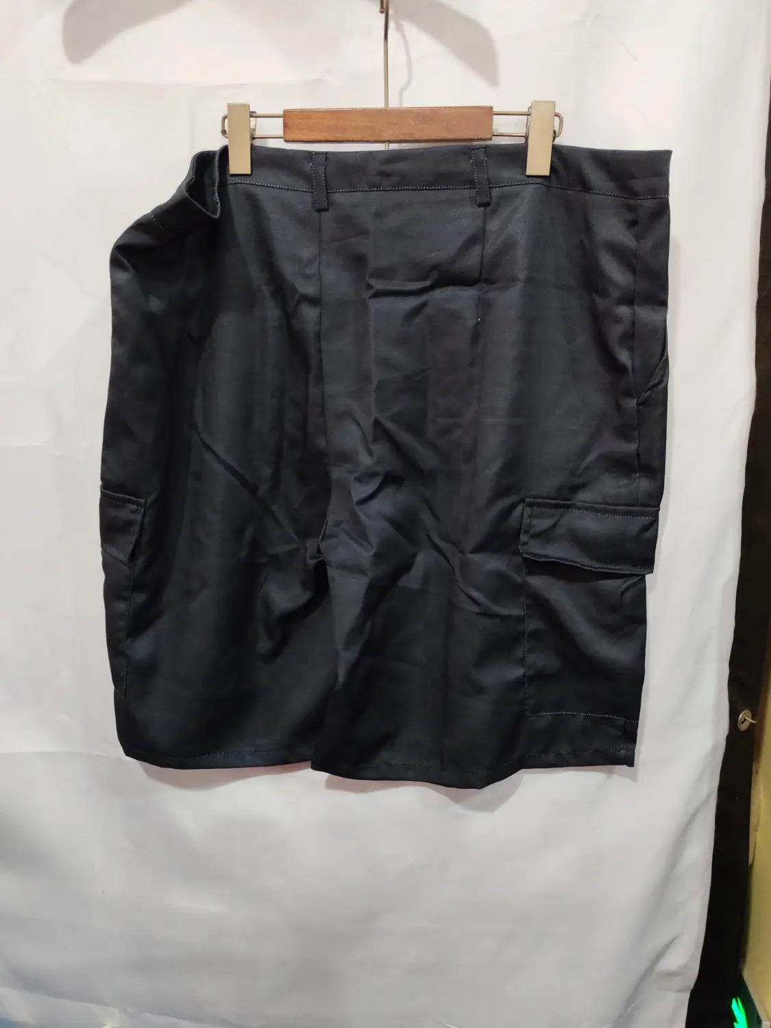 Black cargo skirt with two large side pockets and a straight-cut silhouette made of polyester resembling men’s digital print cargo shorts straight pants.