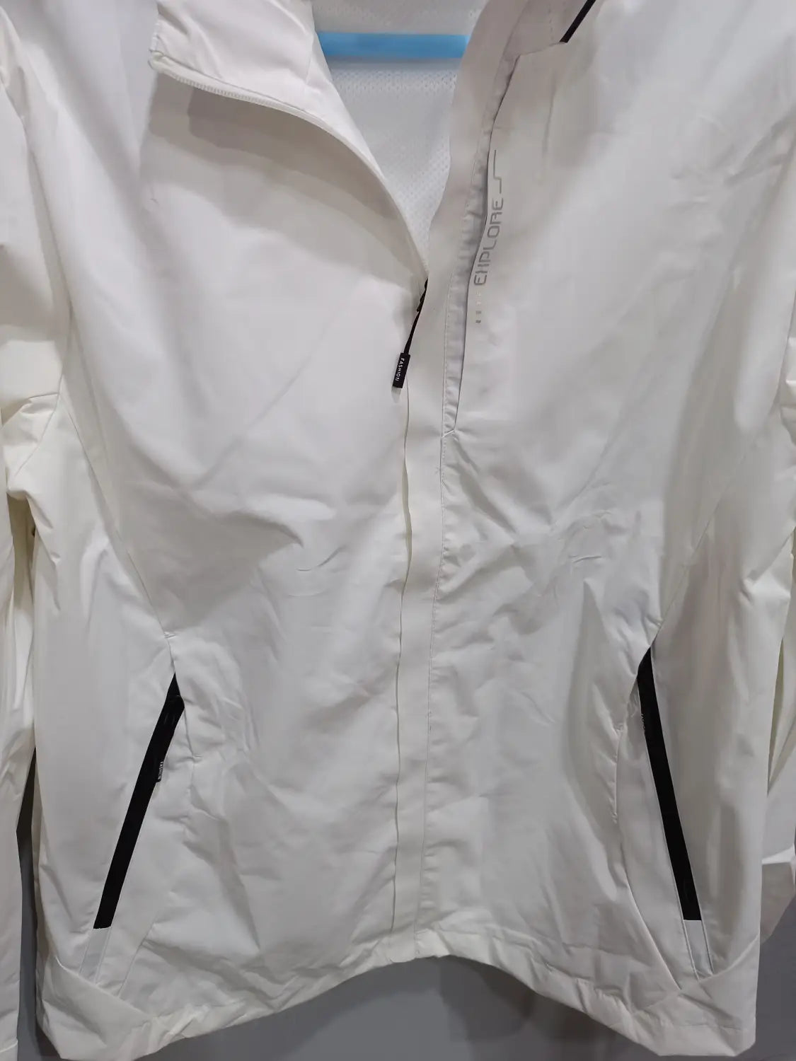 White lightweight waterproof hiking jacket for men featuring black zipper accents and subtle clima branding on the chest designed as a hooded windbreaker.