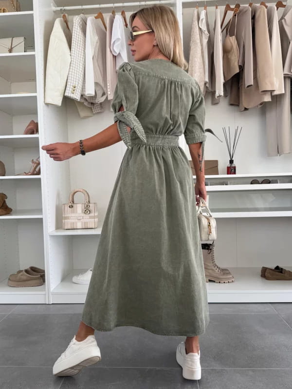 Olive green denim midi dress with puff sleeves and a cinched waist featuring a button front design.
