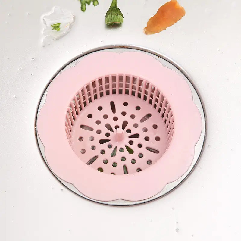 Rosa Kunststoff-Blumenförmiger Siphonfilter mit Rastermuster und zentraler Ablauföffnung als Küchenablauf-Filter für den Abflussstöpsel, 4er-Pack.