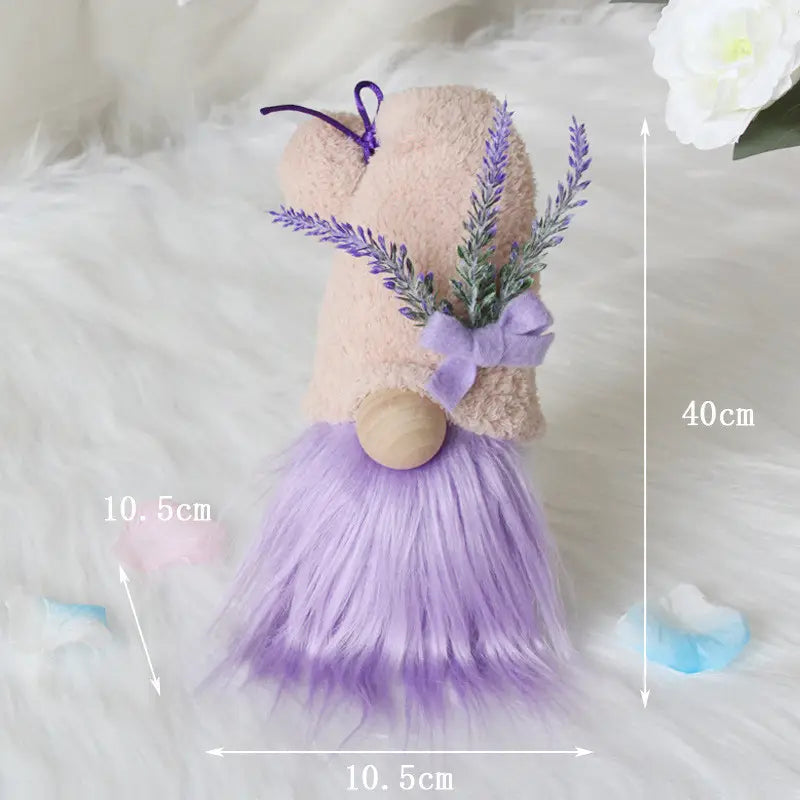 A plush lavender-furred gnome doll with a beige body wooden nose and purple bow-adorned sprigs of faux lavender used as a desktop ornament.