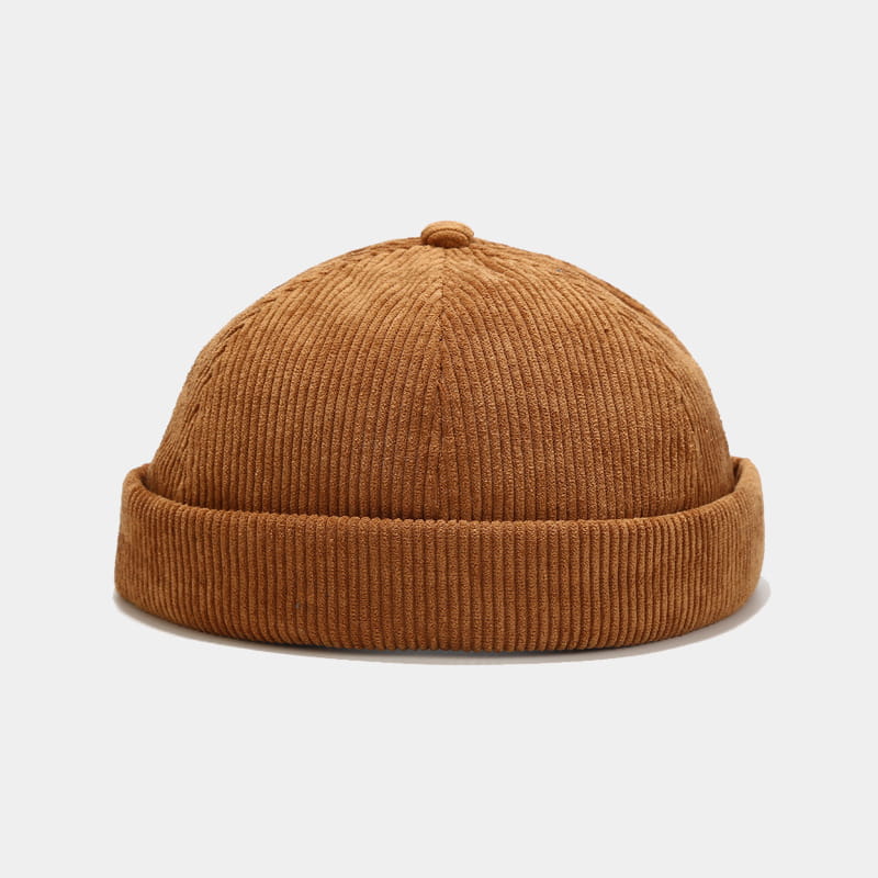 A warm brown corduroy landlord beanie with ribbed texture and folded brim designed as an adjustable streetwear hat.