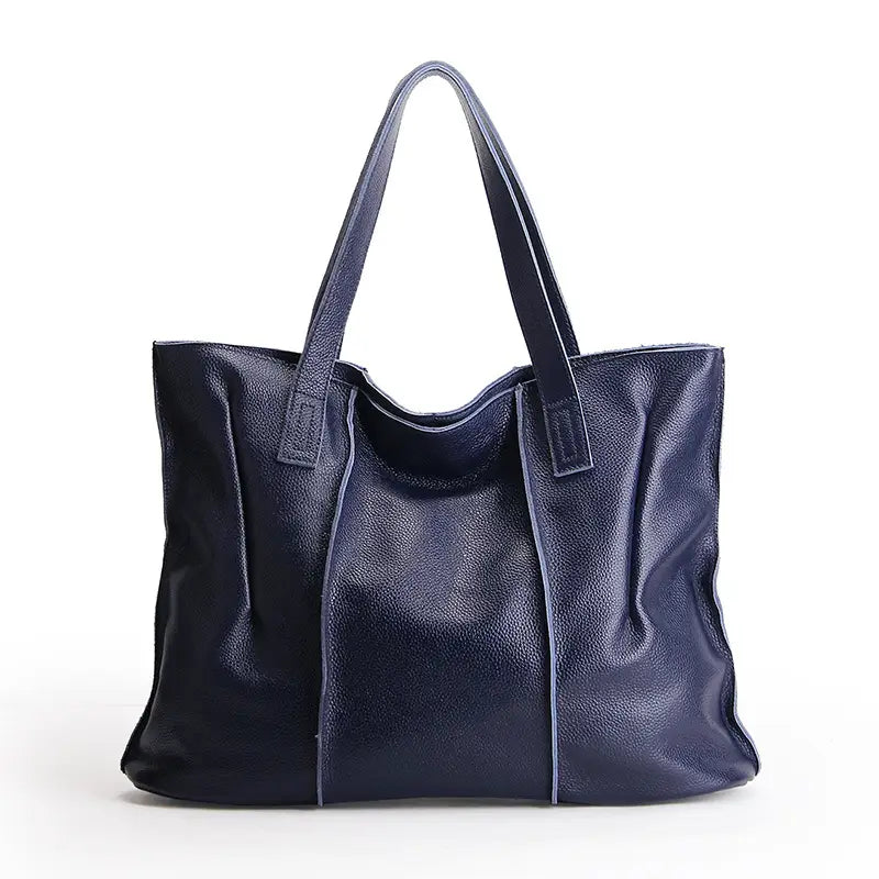 Deep navy leather tote bag with soft pebbled cowhide texture and contrasting light blue stitching for shoulder use.