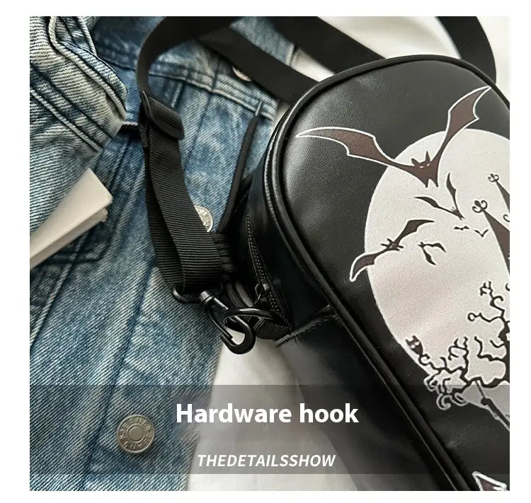 black crossbody bag featuring a white moon and bat embroidered design from the Halloween floral and pumpkin collection