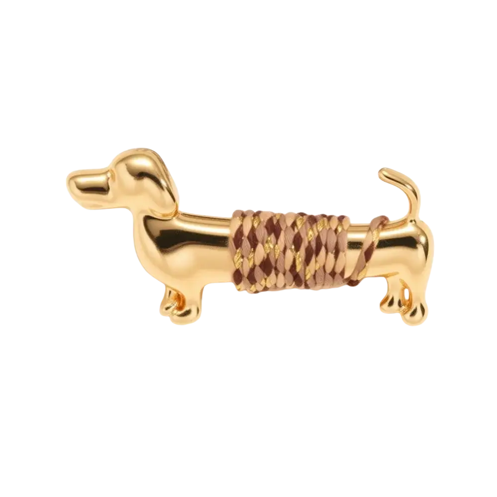 Gold-colored dachshund brooch lapel pin with a woven brown and tan braided cord wrapped around its midsection