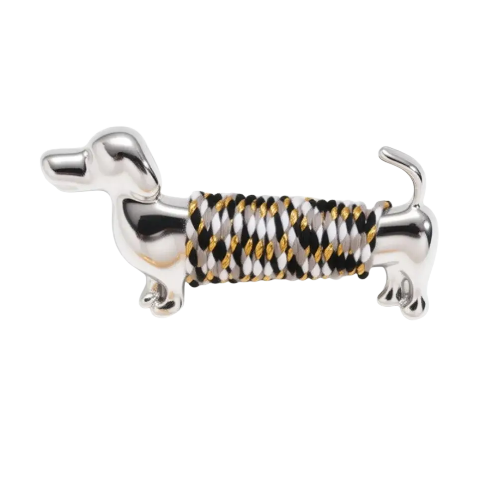 Silver dachshund brooch lapel pin with black white and gold braided cord wrapped body design
