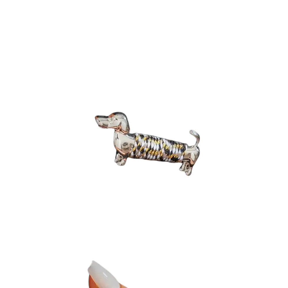 A silver and gold twisted wire dachshund brooch lapel pin featuring a detailed animal design