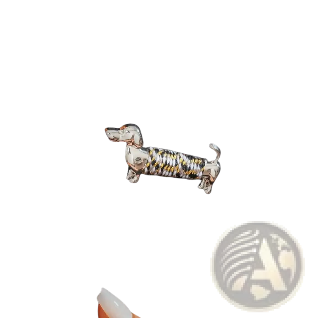 A silver and gold twisted wire dachshund brooch lapel pin featuring a detailed animal design