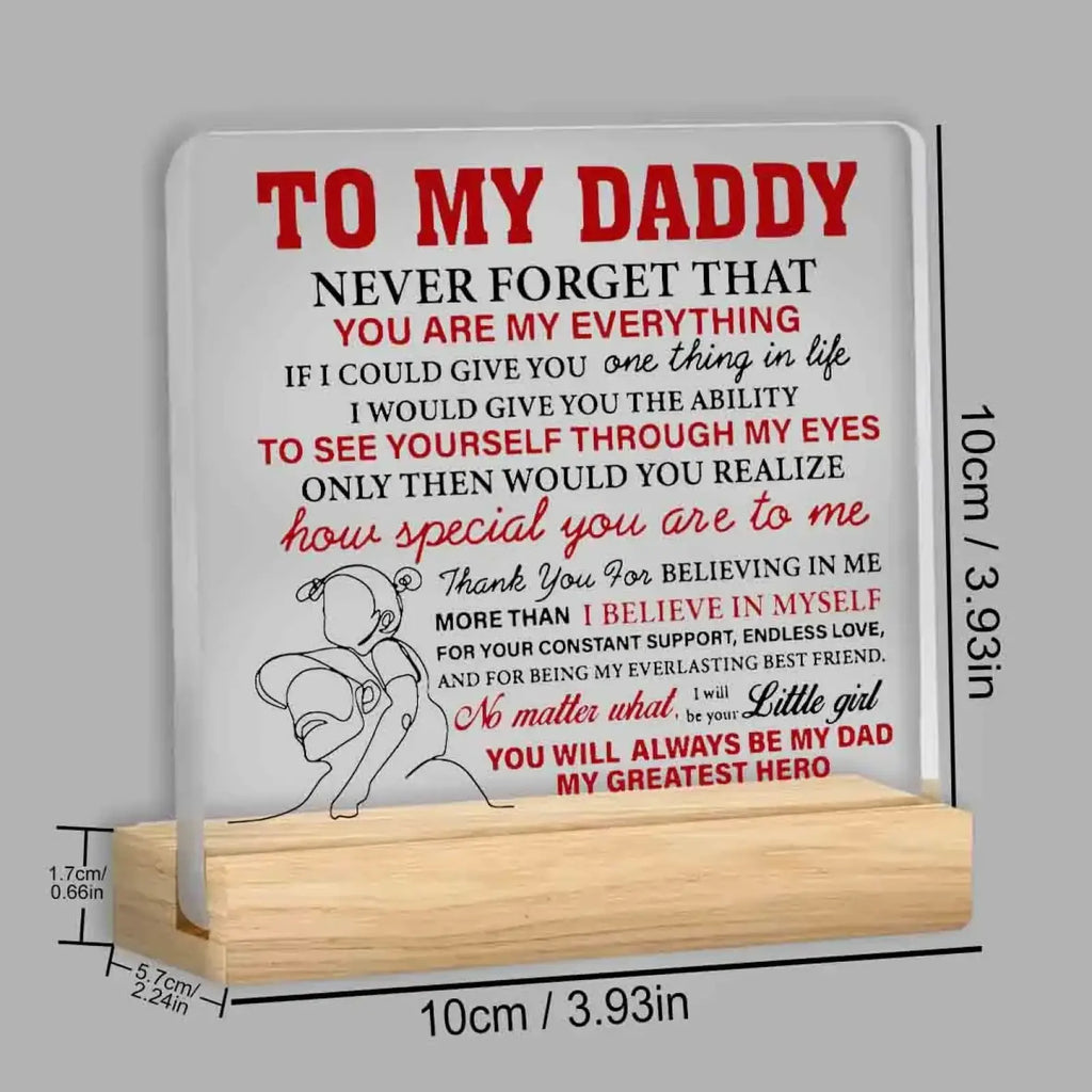 White rectangular acrylic desk sign with red and black text and child hugging adult illustration on light wood stand