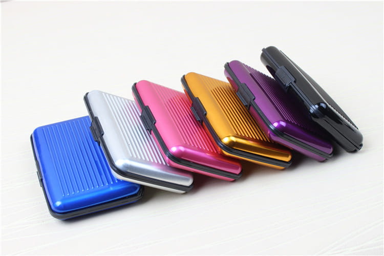 A sleek rectangular metal RFID blocking aluminum alloy ribbed card holder case with a black plastic clasp in vibrant colors including blue silver pink gold purple and black.