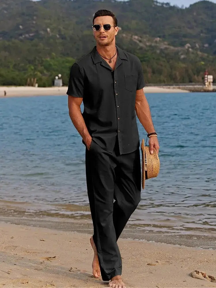 Black short-sleeved mens beach shirt with collar and chest pocket in a casual summer cotton outfit set.